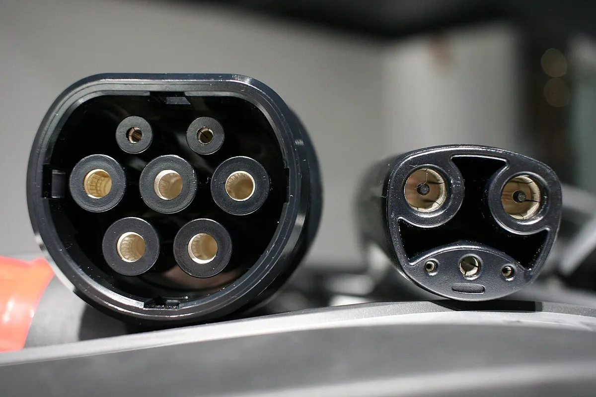 Standardised Tesla IEC w:Type 2 connector female outlet (used in Europe / Rest of World; left) and proprietary Tesla02 outlet (used in North
